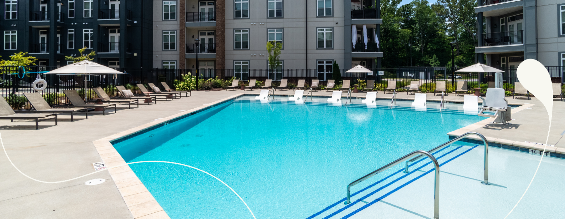 a swimming pool with chairs in a courtyard