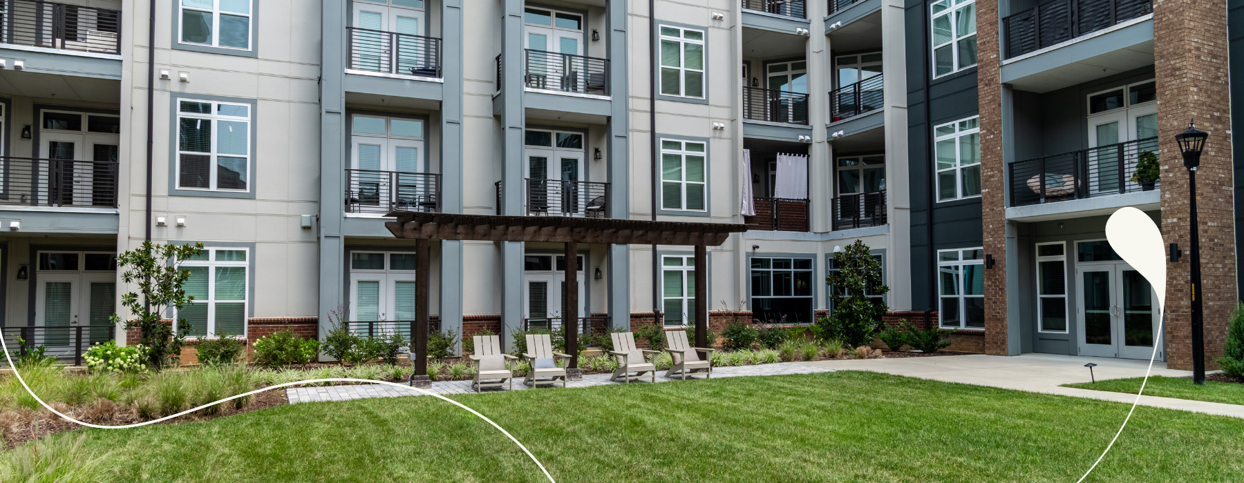 an apartment building with grass