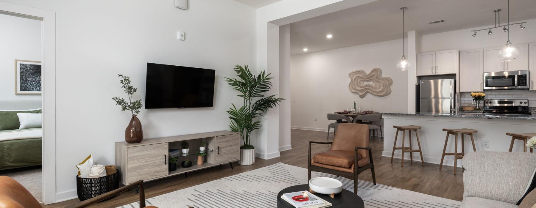 a living room with a tv and chairs