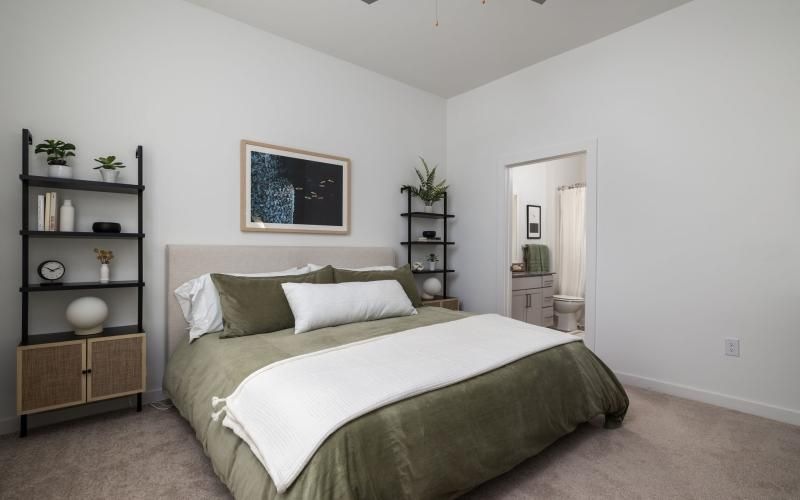a bedroom with a bed and shelves