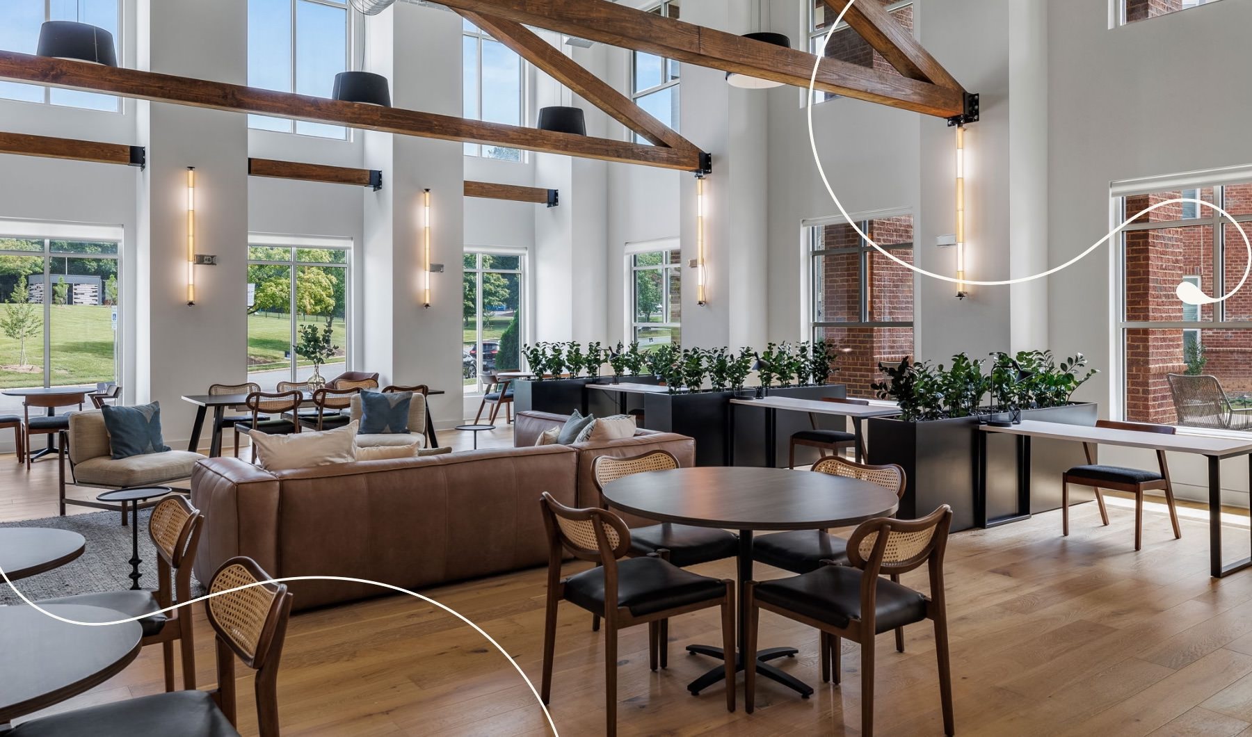 a clubroom with a couch, tables and chairs