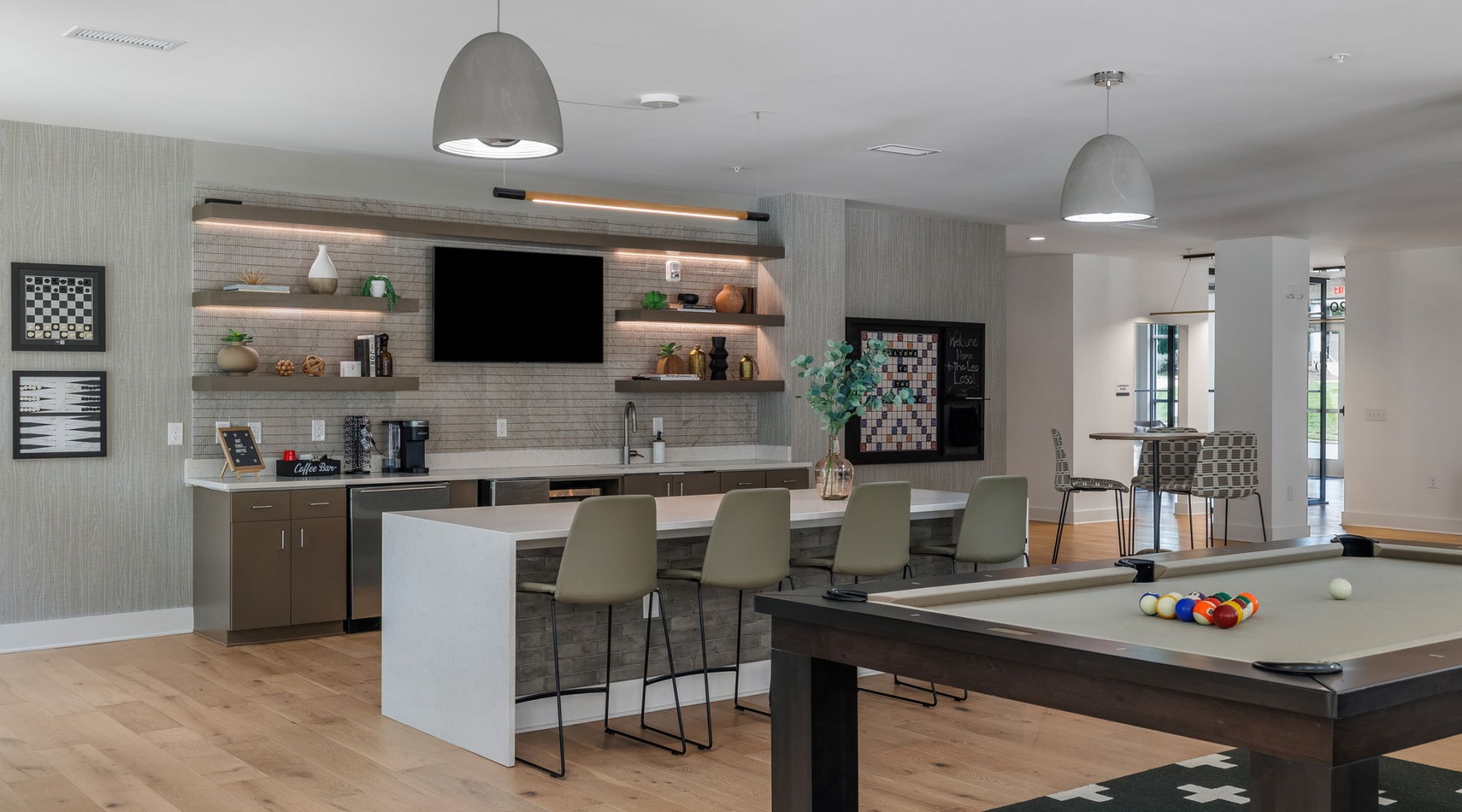 a clubroom kitchen with a pool table