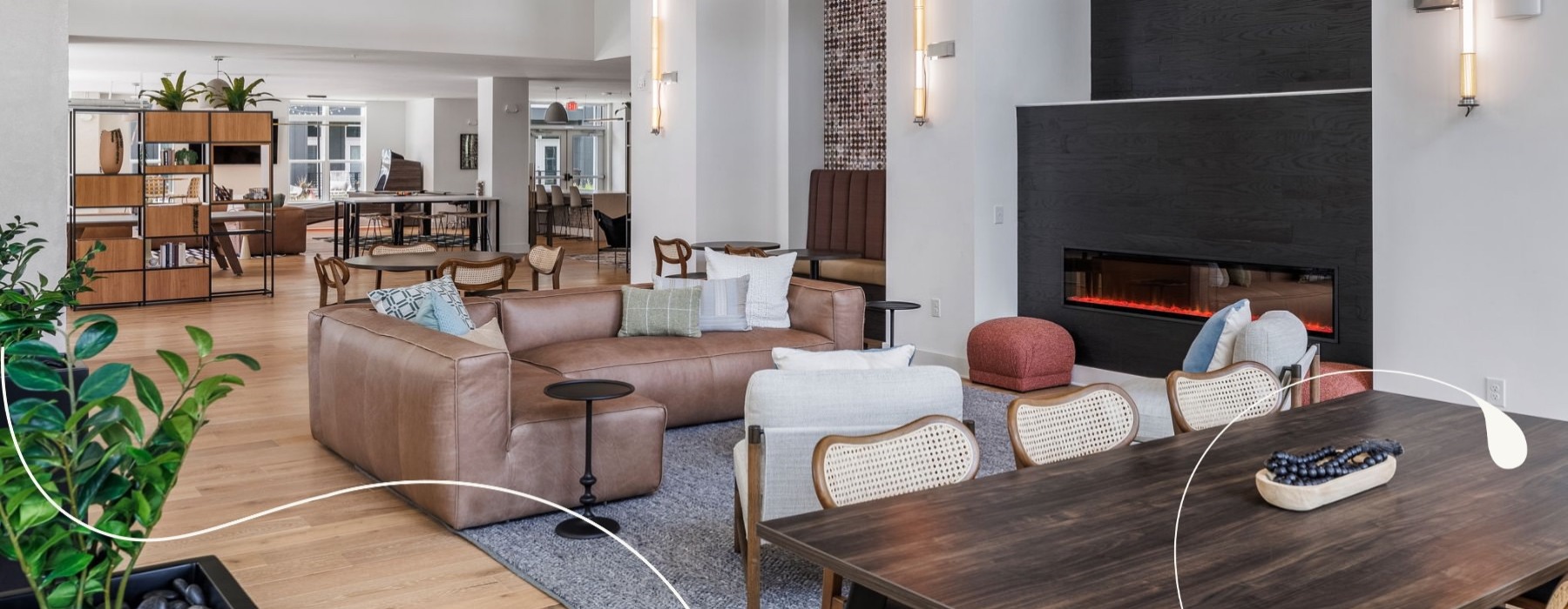 a clubroom with a table, chairs and a couch