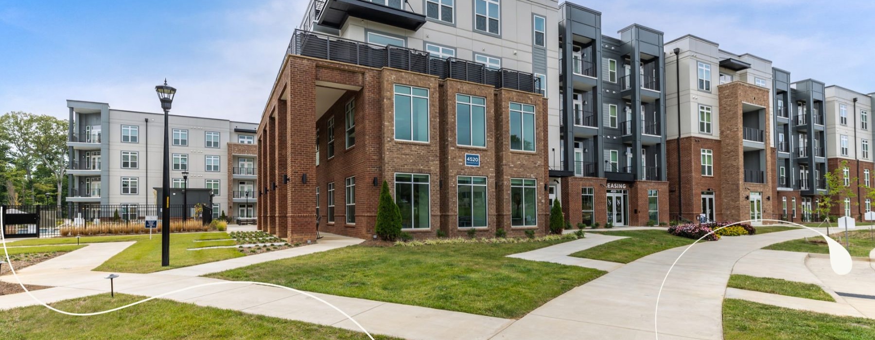 an apartment building with grass
