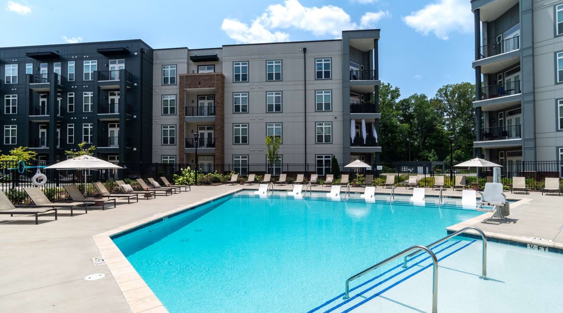 a courtyard with a pool and chairs